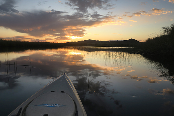 Sunrise on Mittry Lake kayak fishing with watermanatwork.com