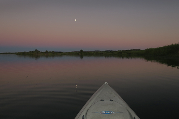 Kayak fishing under a full moon on the Colorado River