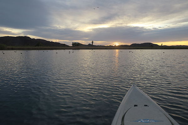 A cloudy winter sunrise kayak fishing on the Colorado River