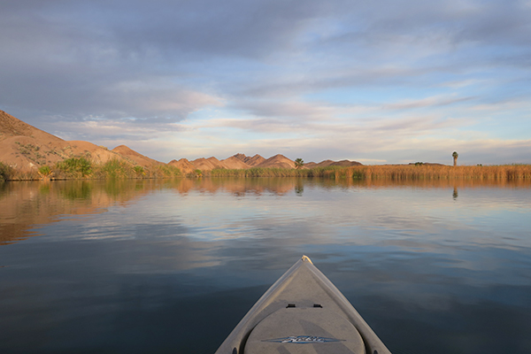 The morning sun begins to burn through the clouds over the Colorado River