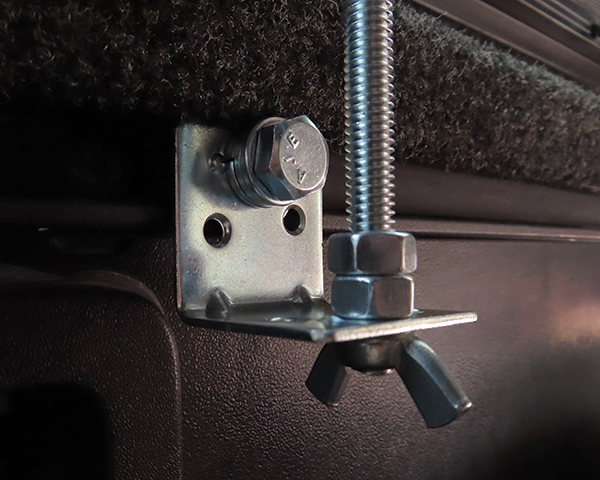 Simple and inexpensive radio mount for a pickup truck with bed rails